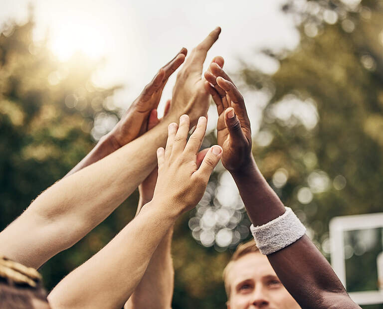 Basketball, winner and hands, team high five for outdoor game. Success, diversity and victory goal for sports for men. Teamwork, diversity and support, friends on basketball court together with coach