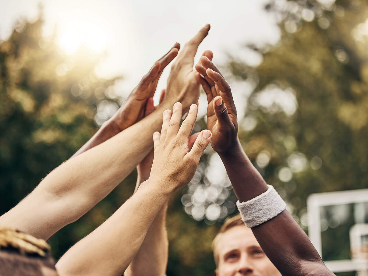 Basketball, winner and hands, team high five for outdoor game. Success, diversity and victory goal for sports for men. Teamwork, diversity and support, friends on basketball court together with coach